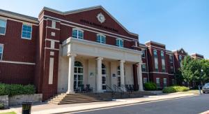 Exterior of a large brick building with white awning and pillars
