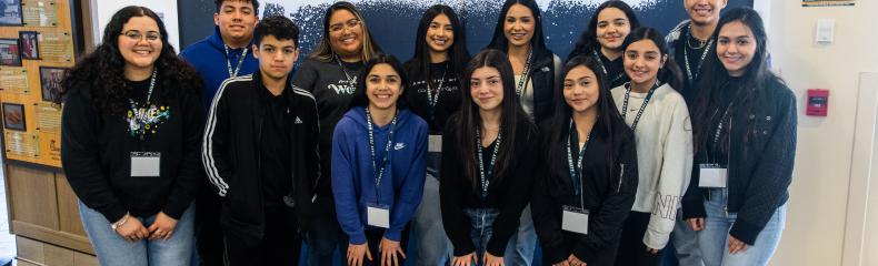 A group of people standing together underneath a sign that reads, "Congreso"