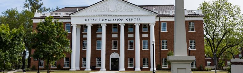 A brick academic building at East Texas Baptist University with a blue sky in the background.