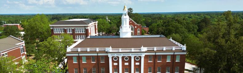 A drone image of a brick academic building at East Texas Baptist University