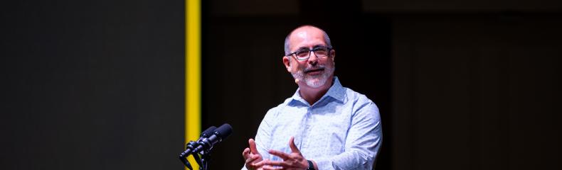 A man speaking from behind a podium