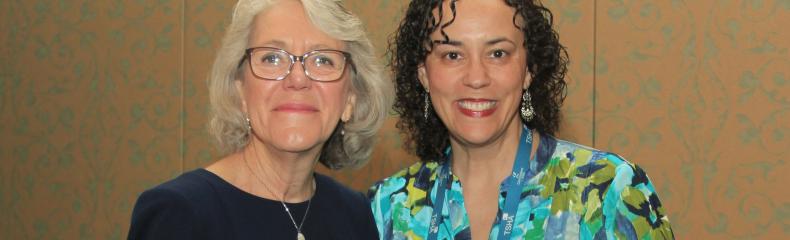 Two women smiling at the camera 