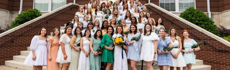 Participants in ETBU's 77th annual Senior Girl Call-Out stand on the back steps of Ornelas Student Center for a group photo