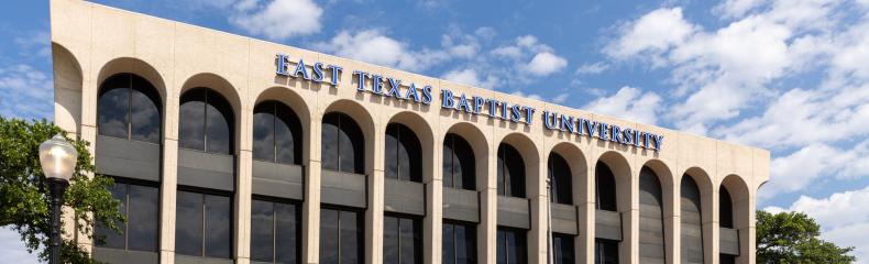 The exterior of a building with writing that says, "East Texas Baptist University"