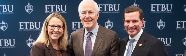 3 people standing in front of an ETBU backdrop smiling